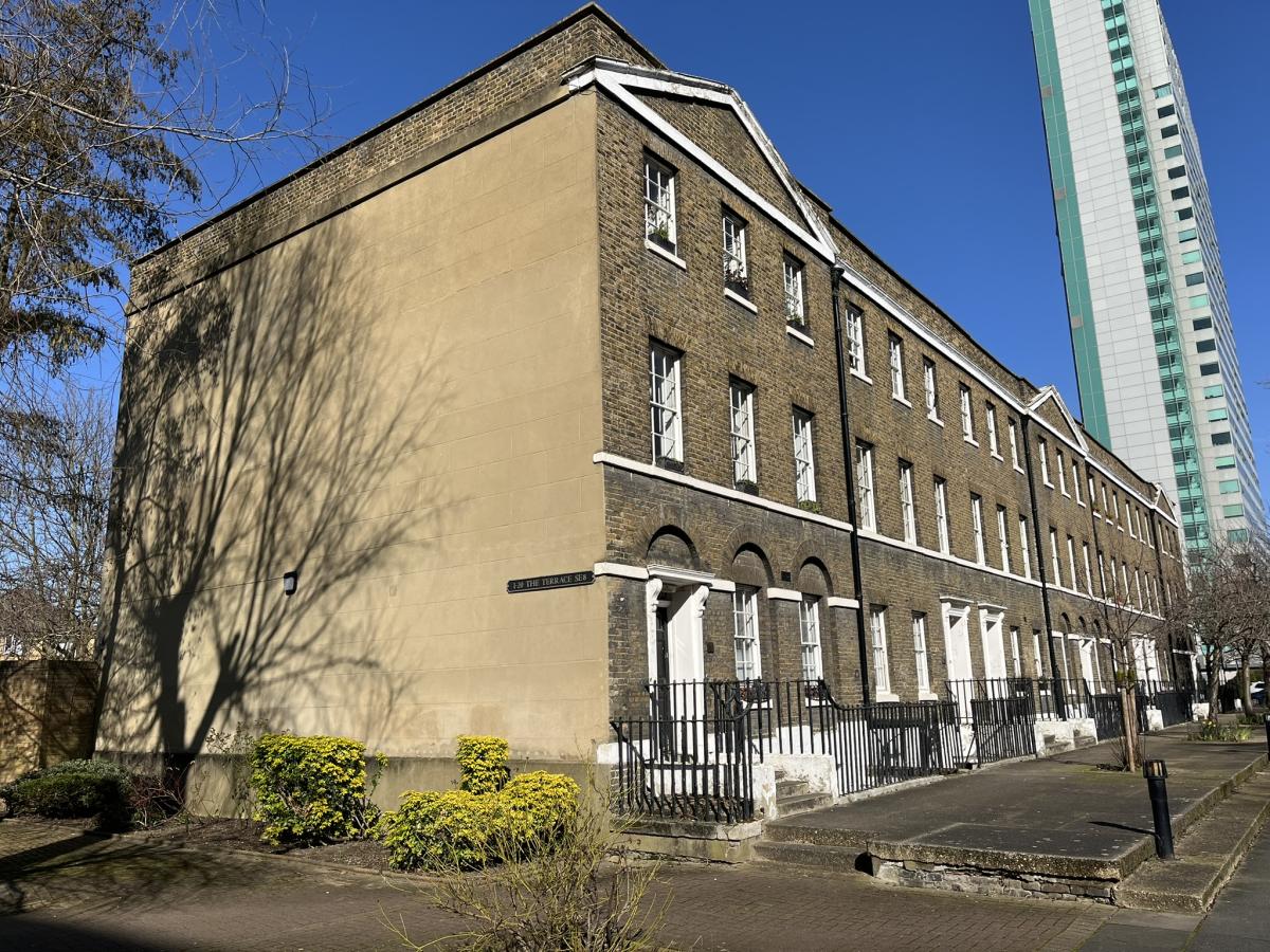Council flats with a taller block of flats behind to the right