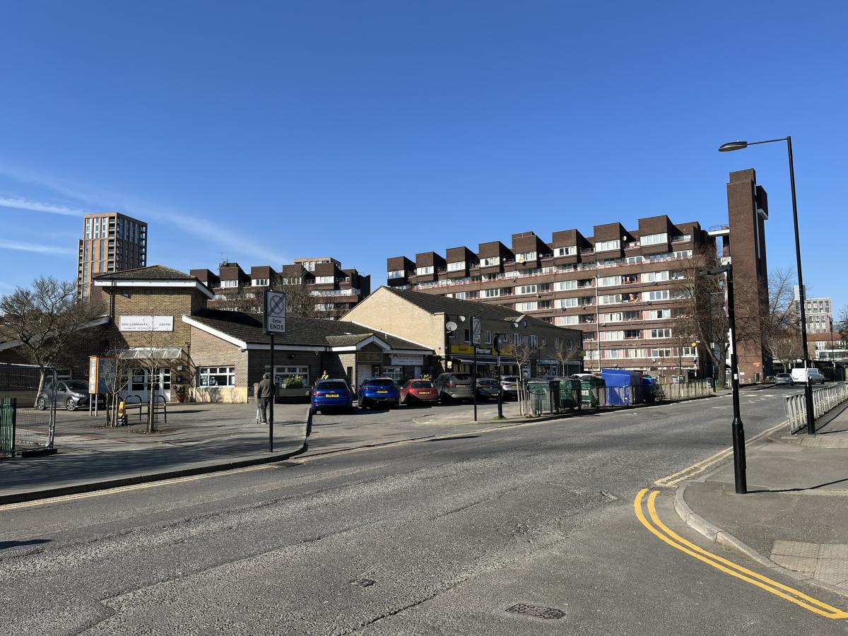 Brick red council flats, taken from across the road